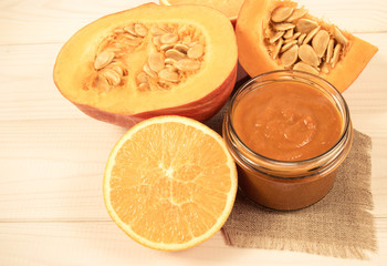 Homemade preserves. Pumpkin jam on a wooden background.