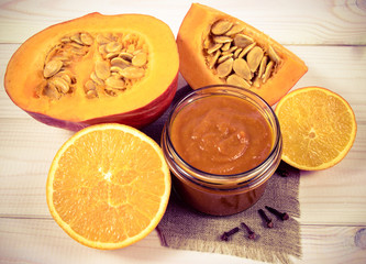 Homemade preserves. Pumpkin jam on a wooden background.