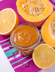 Homemade preserves. Pumpkin jam on a wooden background.