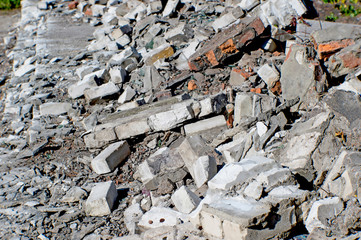 The remains of the Foundation of the building in the form of a pile of white and red bricks
