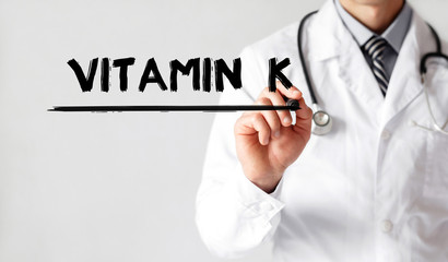 Doctor writing word Vitamin k with marker, Medical concept