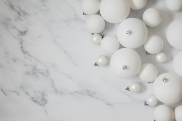 Christmas composition. white festive ball decorations on a marble background