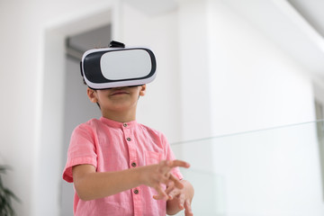 kid at home playing games on vr glasses
