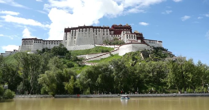 4k timelapse clouds rolling Potala in Lhasa,Tibet.lake with willow in lasa park.