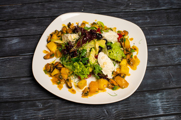 Serving the New Year's table for several people with a Christmas tree. Photos in the interior