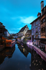 Panorama of traditional Alsatian half-timbered houses and river Lauch in little Venice quarter, old town of Colmar, Alsace, France