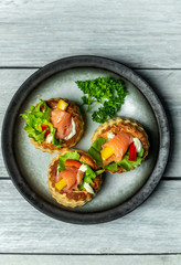 French cuisine, crunchy patties with lettuce and smoked salmon on a bright, rustic background