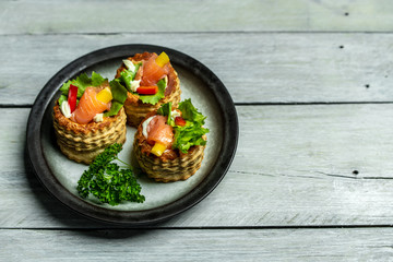French cuisine, crunchy patties with lettuce and smoked salmon on a bright, rustic background