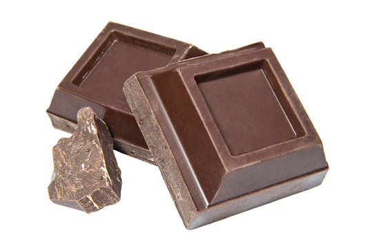 Slices of dark chocolate on a white background.