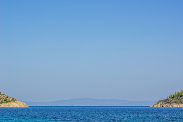south Mediterranean wallpaper patter  landscape with two symmetry island and sea bay vivid blue water surface and empty sky, copy space, tourist agency and summer vacation holidays concept