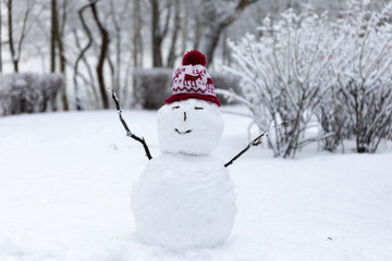 Winter mood: Small simplistict snowman in Christmas hat