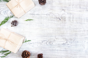 Christmas gifts on a white wooden background  with fir tree and pine cones on , New Year gifts ,Top view with copy space