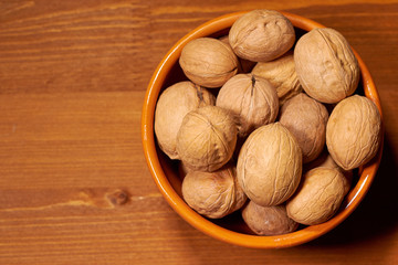 Walnut on brown wooden background. Selective focus
