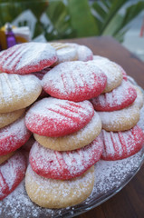 Pink and natural cookies with powder sugar