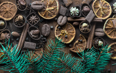 Christmas sketch. Lots of chocolate and chocolates, cinnamon, orange dried slices and spruce twigs. Holiday Decor. Close-up.