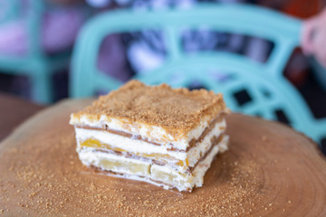 Delicious mango float cake on wood table