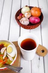 Lontong-Traditional Malaysian and   Indonesian food on wooden table with spoon.