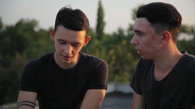 young best friends talking outdoors,sunset,sunlight background