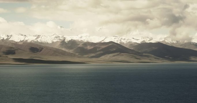 4k time lapse of huge clouds mass rolling over lake namtso & Tanggula snow mountain peak,tibet mansarovar,Tibet's second largest lake,is the third largest saltwater lake in China.