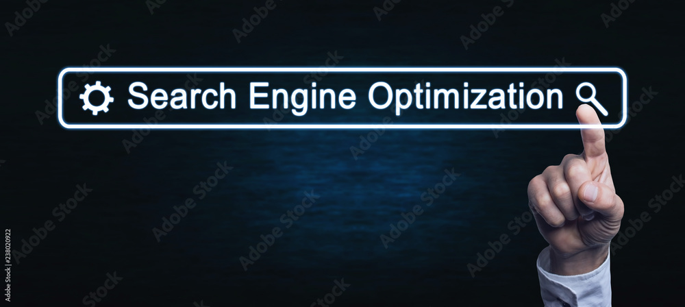 Wall mural hand touching on search engine optimization text.