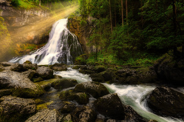 Sunrays over the Gollinger waterfall at morning, Austria, Europe