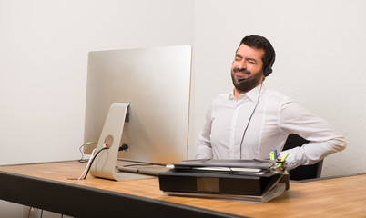 Telemarketer man in a office suffering from backache for having made an effort