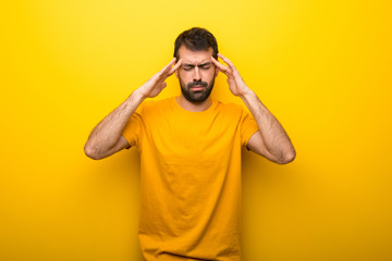 Man on isolated vibrant yellow color unhappy and frustrated with something