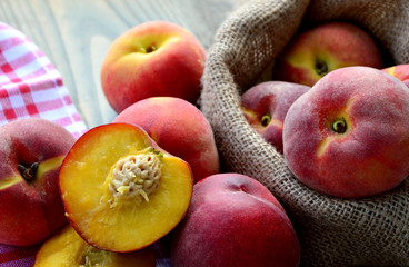 Many fresh peach in sack bag (German name is Pfirsich)