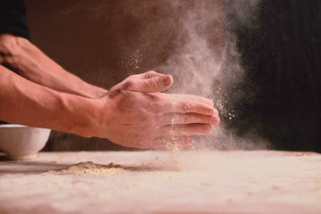 Obraz na płótnie Canvas hands kneading dough on wooden table