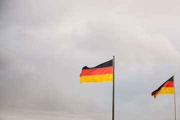 German national flags in the wind against the sky