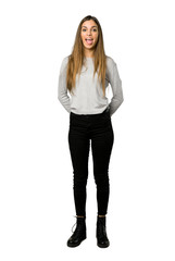 Full-length shot of young girl showing tongue at the camera having funny look on isolated white background