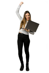 Full-length shot of young girl with laptop and celebrating a victory on isolated white background