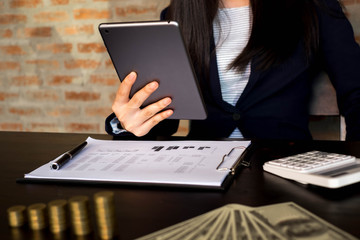 Businesswoman using tablet to the situation on the market value , Business concept.