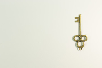 The vintage gold key on white background.