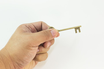 The vintage gold key in hand close up image.