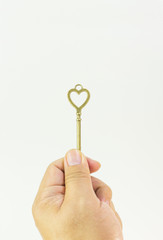 The vintage gold key on white background.
