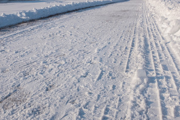 Fototapeta na wymiar A snow-covered road in the winter season