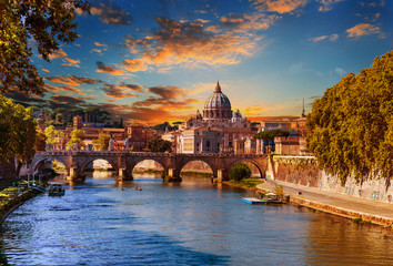 Colorful sky over Saint Peter dome and Tiber river in Rome at sunset