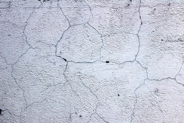 Cracks on the concrete wall close-up