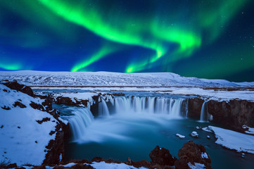 Northern Light, Aurora borealis at Godafoss waterfall in winter, Iceland.