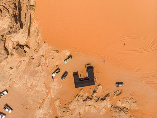 Vertical aerial photograph of a Bedouin tent and parked SUV in the desert nature reserve Wadi Rum, Jordan, taken with the drone