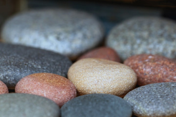 Fototapeta na wymiar multicolored decorative stones, close up, blurry background