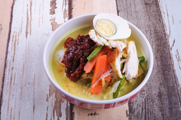 Lontong-Traditional Malaysian and   Indonesian food on wooden table .