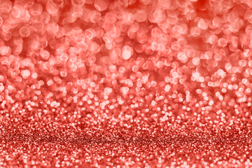 Blurred glitter background in living coral color. Color of the year 2019.