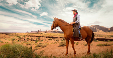 Cowboy in leather clothes riding a horse, western