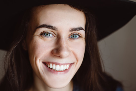 Portrait of beautiful young happy woman wearing  black hat .