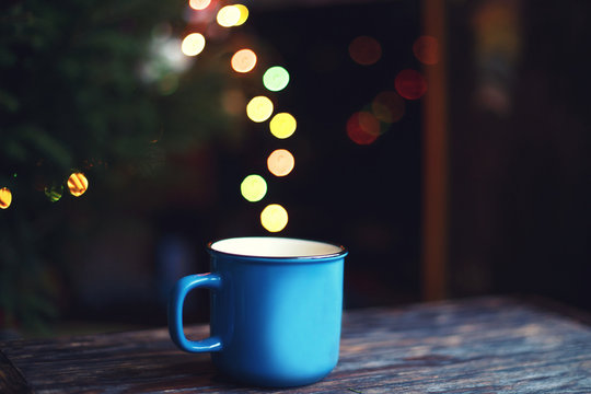 a cup on the wooden background . Christmas bokeh