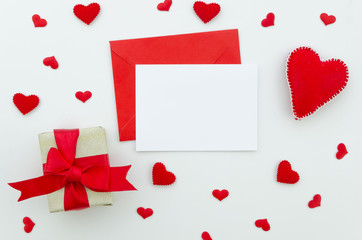 Valentine day composition: gift box with ribbon and red felt hearts, photo template, background. Top View. View from above. Valentine card mockup with envelope