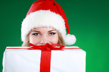 Smiling young woman holding christmas gifts