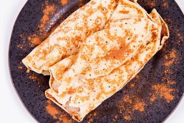 Pancakes stuffed with braised apples sprinkled with cinnamon